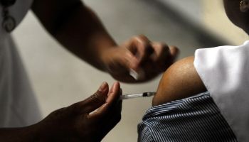 Nurse injecting a vaccine against the H1N1 or swine flu influenza at a hospital, Colombo, Sri Lanka