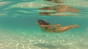 Full Length Of Woman In Bikini Swimming In Sea