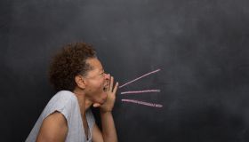 Senior woman in front of blackboard pretending to shout