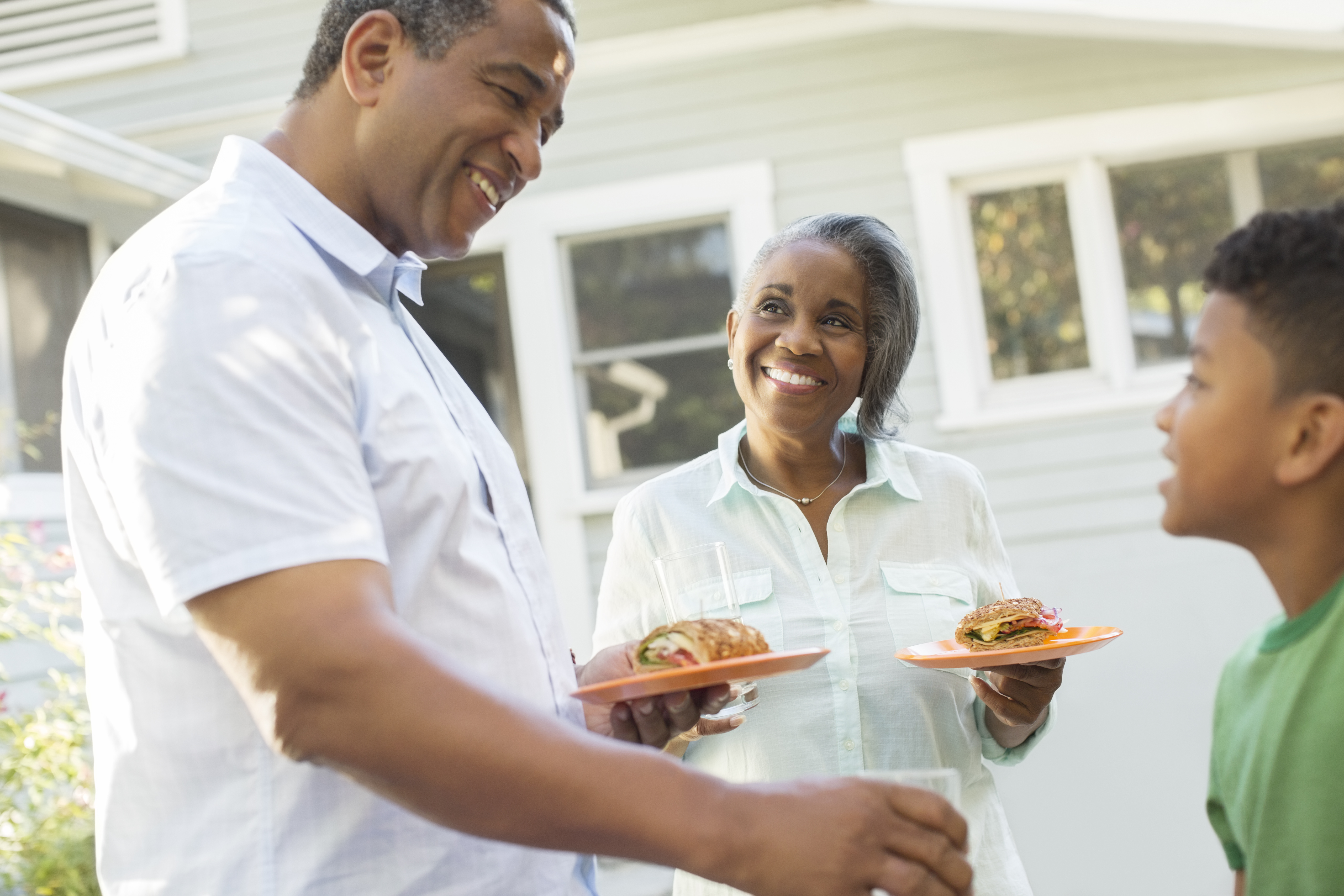 Grandparents and grandson enjoying barbecue on patio