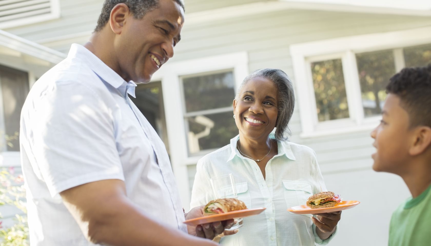 Grandparents and grandson enjoying barbecue on patio