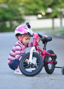 Girl, aged 3, fixes bicycle