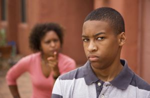 Upset teen and mother outside of house