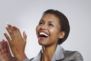 Happy businesswoman clapping hands