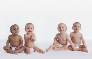 Portrait of Four Babies Sitting in Their Nappies
