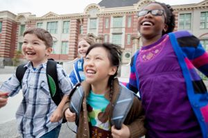 elementary students running outside school