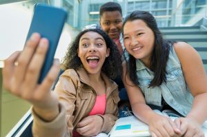 Students taking selfie on stairs