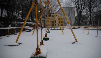 Japan, Tokyo Metropolis, Tama City, Snow covered swings in playground