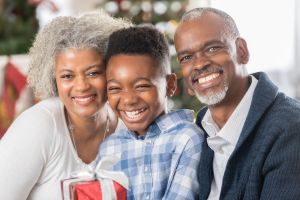 Happy grandparents with grandson on Christmas day