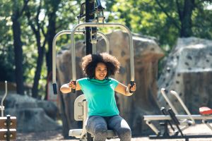 African woman doing fitness workout in park
