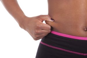 Belly of a young sexy african american woman, isolated on white background