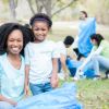 Mother volunteers with young daughter for community cleanup