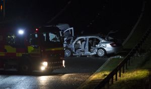 Scottish police along with the Fire and Rescue Service tend to a road traffic accident near Linlithgow