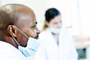 Masked medical professionals in surgery smile