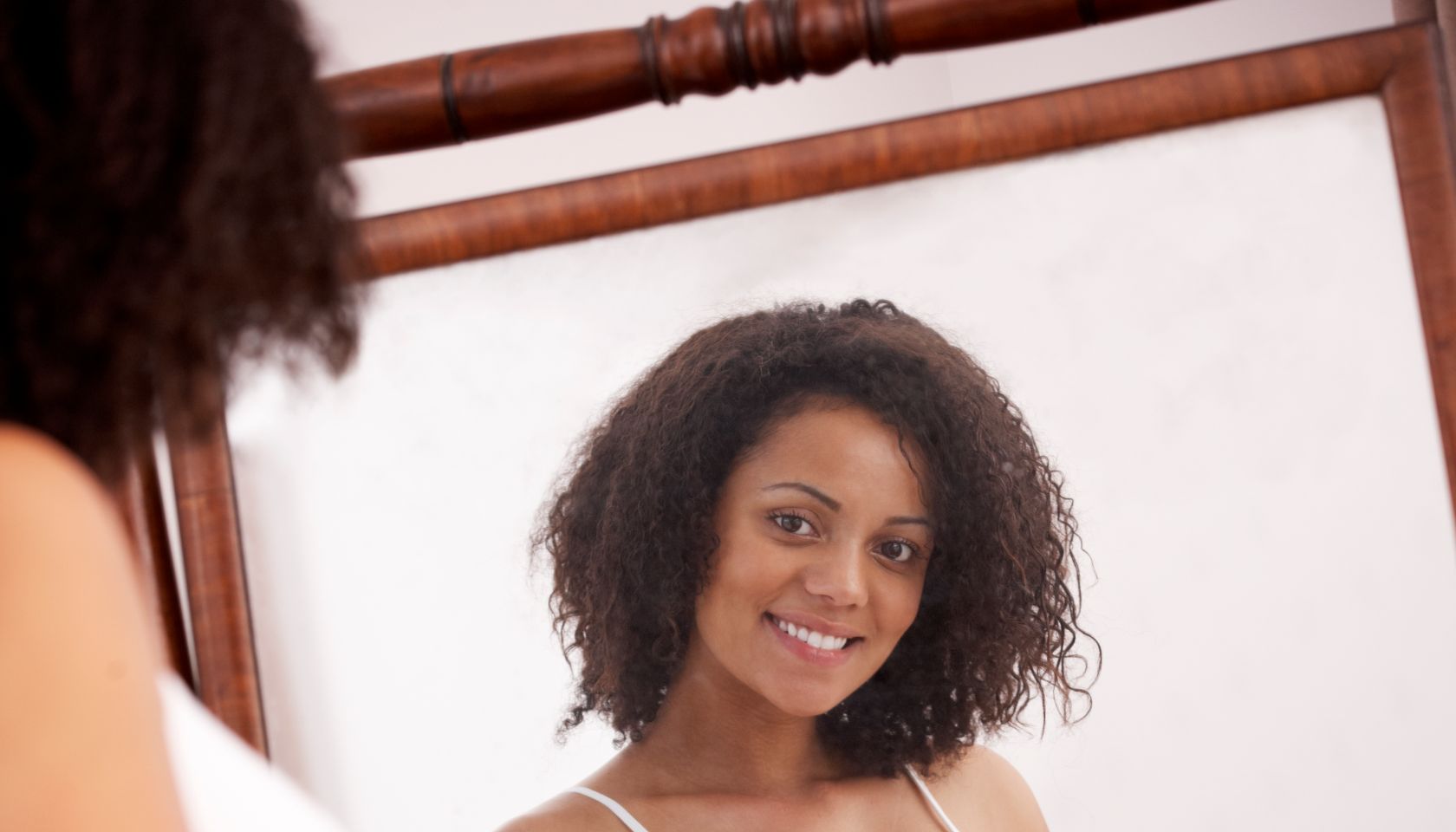 Pregnant woman looking in mirror