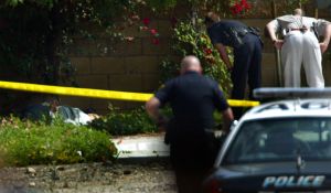 Arcadia and El Monte police investigate the scene where an armed bank robber was shot and killed by