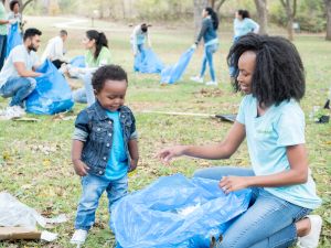 Mother teaches toddler son how to help community