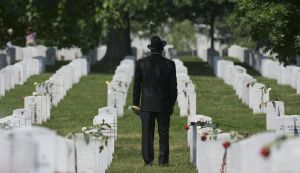 ARLINGTON, VA - MAY 30: A visitor to Arlington Cemetery pays his
