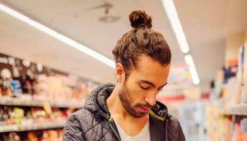 Young Bearded Man In A Supermarket.