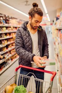 Young Bearded Man In A Supermarket.