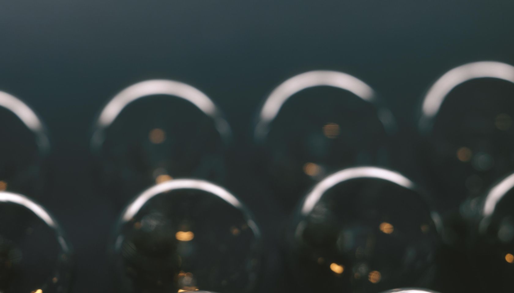 Glowing light bulb against dark background