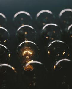 Glowing light bulb against dark background