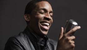 African American man singing into microphone