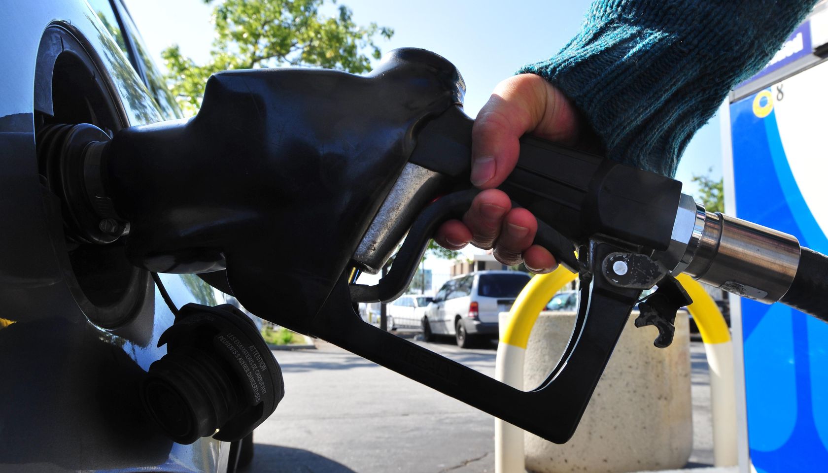 A woman pumps gas into a vehicle on Marc