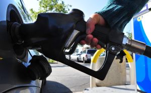 A woman pumps gas into a vehicle on Marc