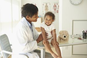 Doctor examining baby in doctor's office