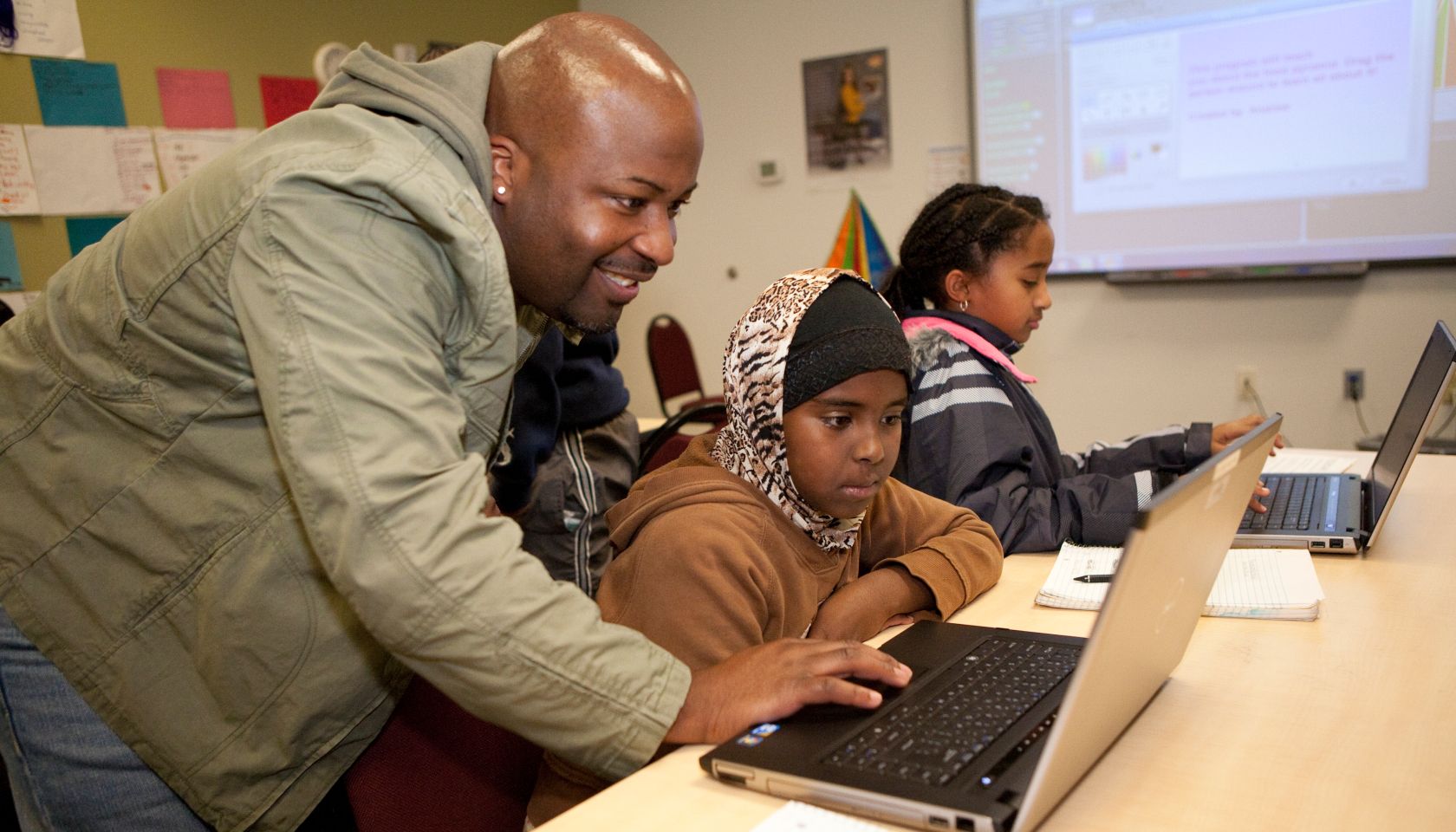 Girl and teacher at computer class