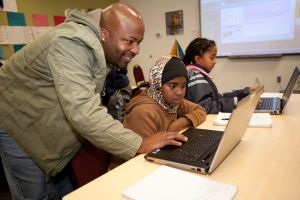 Girl and teacher at computer class