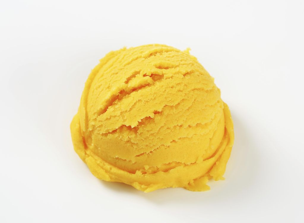 Scoop of yellow ice cream - studio shot