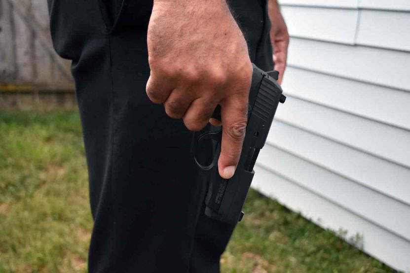 Police Officer holding handgun pistol