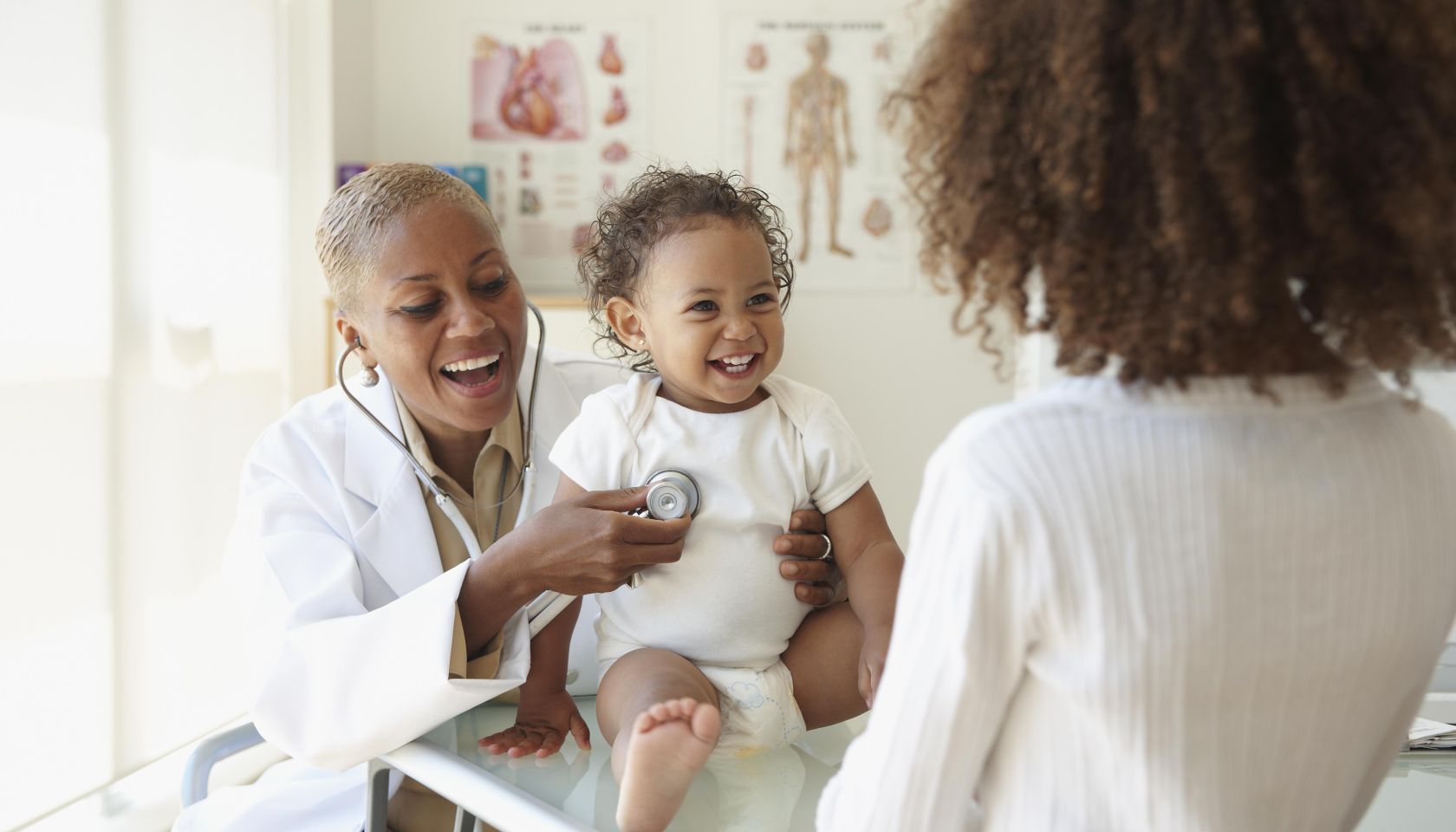 Doctor listening to baby's breathing with stethoscope