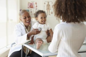 Doctor listening to baby's breathing with stethoscope