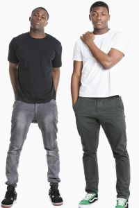 Portrait of two young men in casuals over gray background