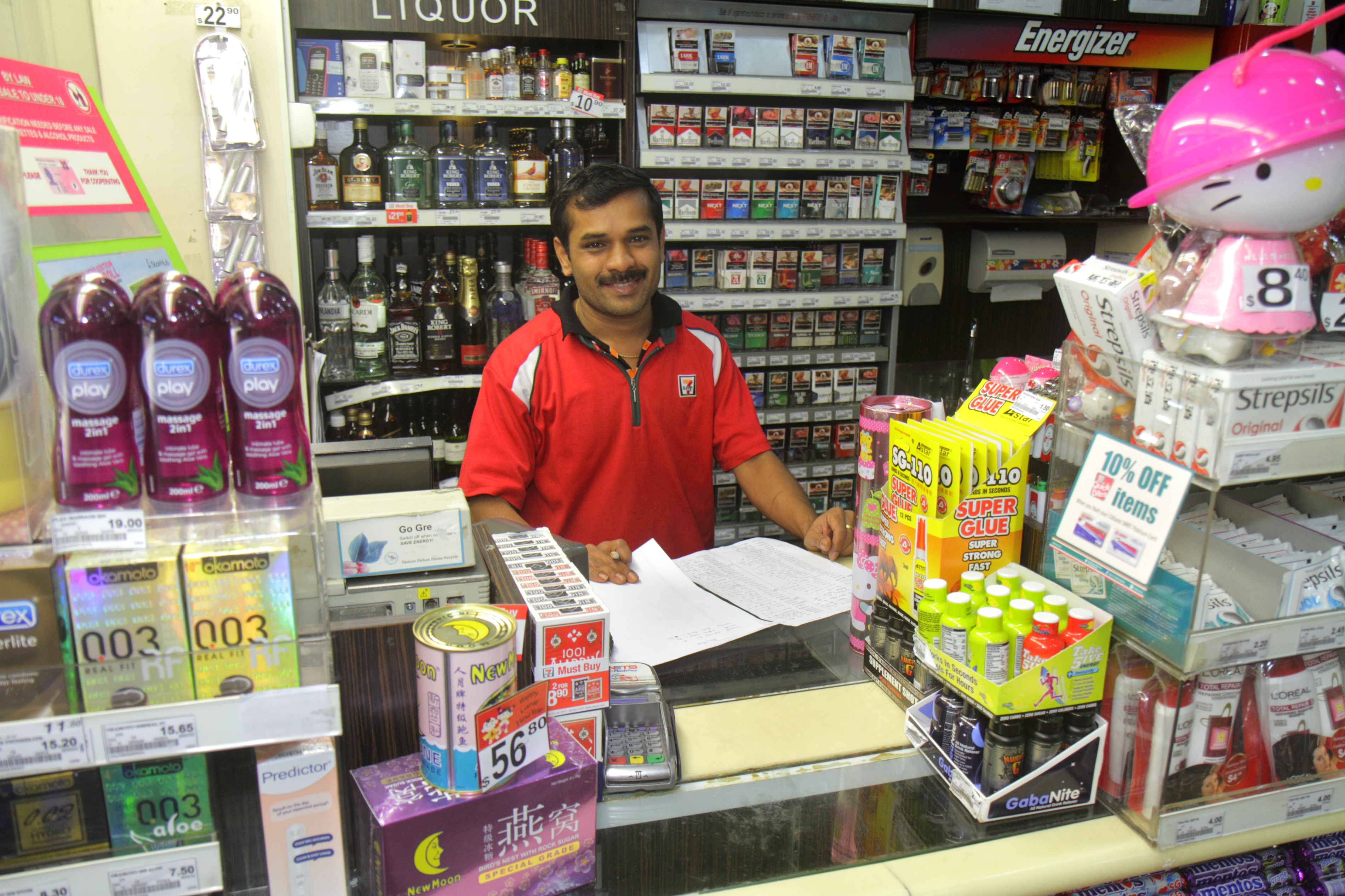 A cashier inside 7-Eleven.