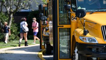 Buses wait outside Long Island high school at the end of first day of school in 2020