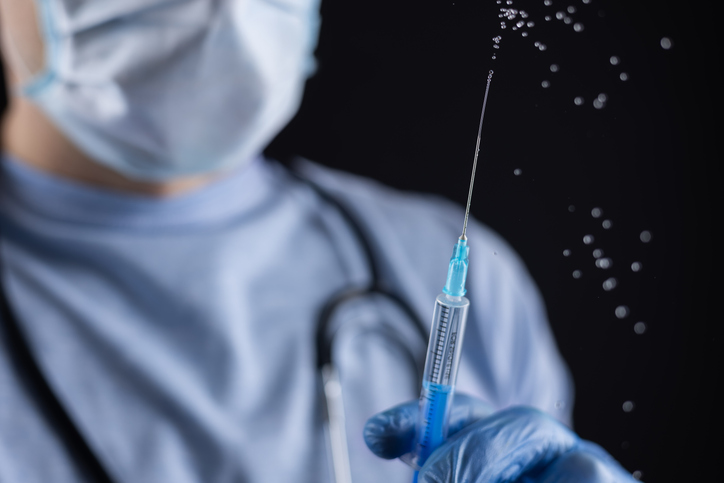 Doctor, or scientist hand in blue nitrile gloves holding flu,