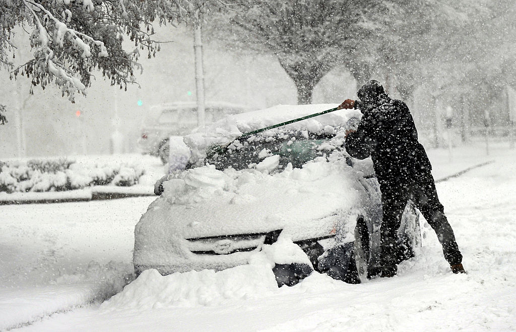 nt030818ntwea-1005 - man clears snow off