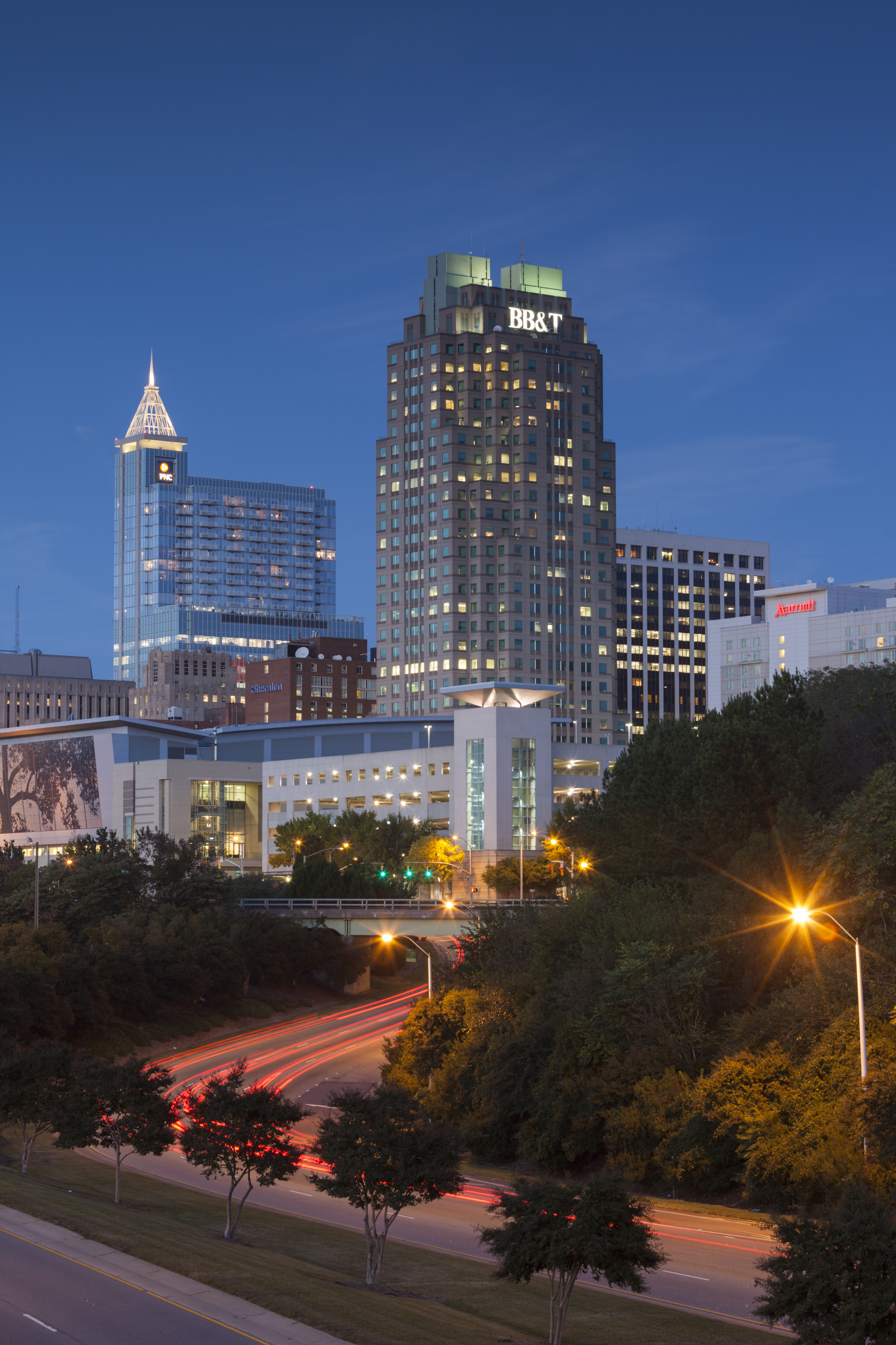 Empty road with urban skyline on background at dusk, Raleigh, North Carolina, USA