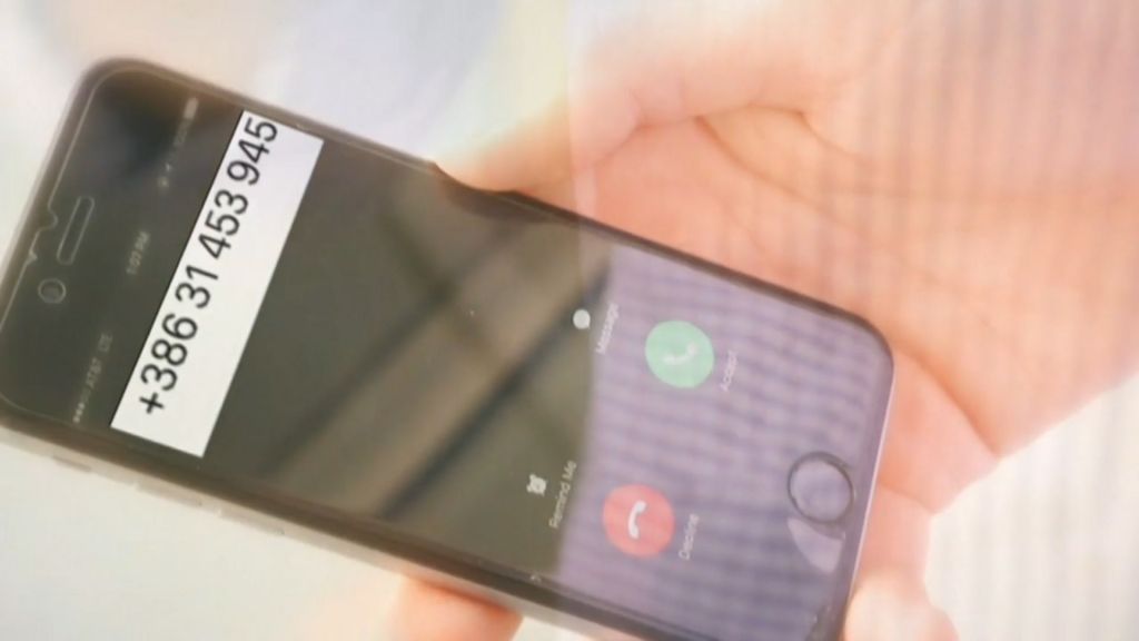 A hand holding a smartphone displaying a phone number +38631453945.